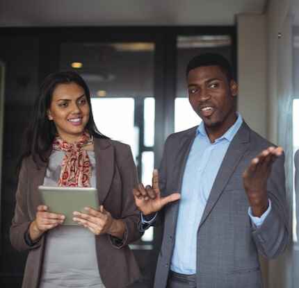 businessman-discussing-white-board-with-colleague-normal (cropped)