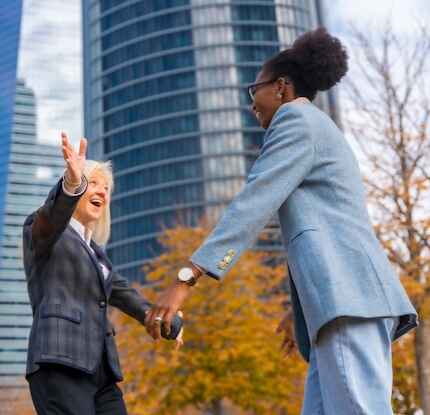 executives-hugging-outside-office-normal (cropped)