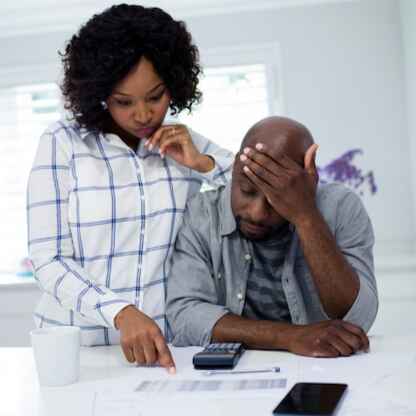 worried-couple-interacting-while-checking-bills-normal (resized)